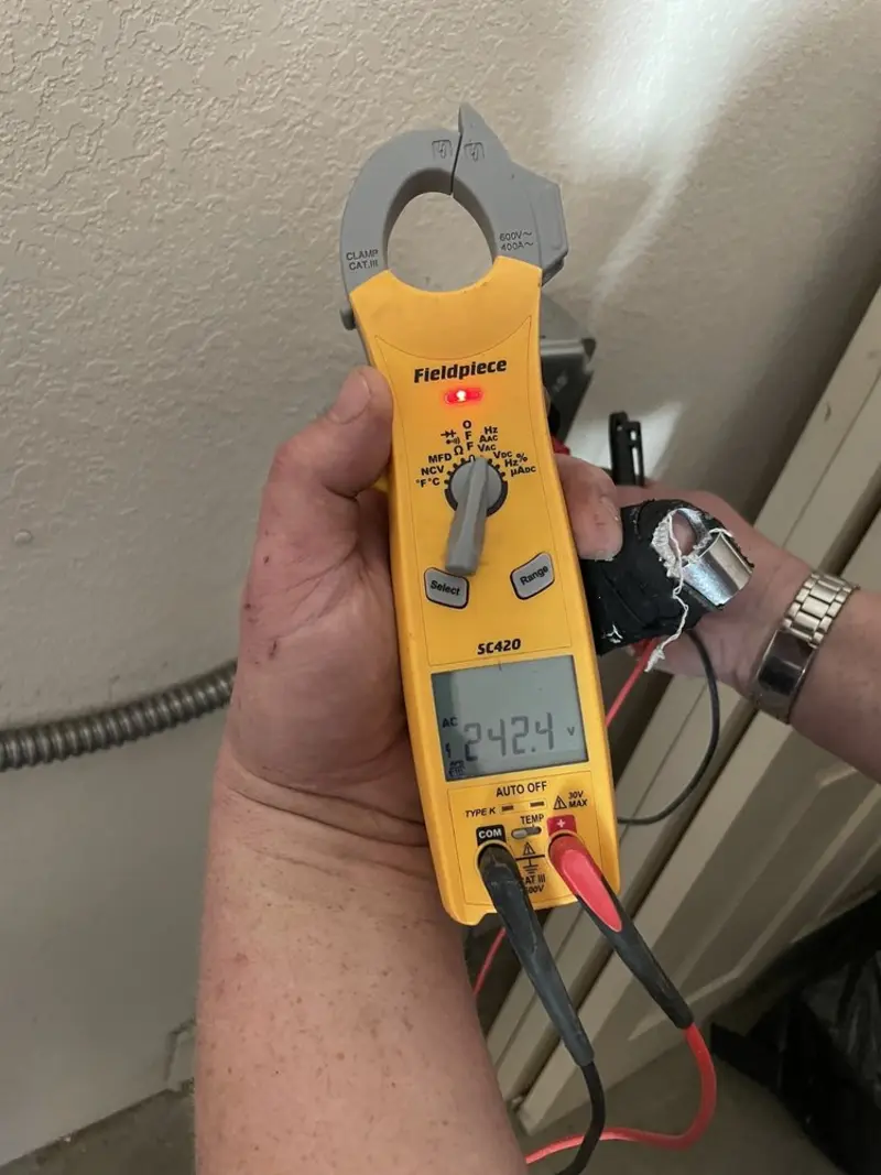 Voltage testing with clamp meter during Ceiling Fan Installation in Cobleskill